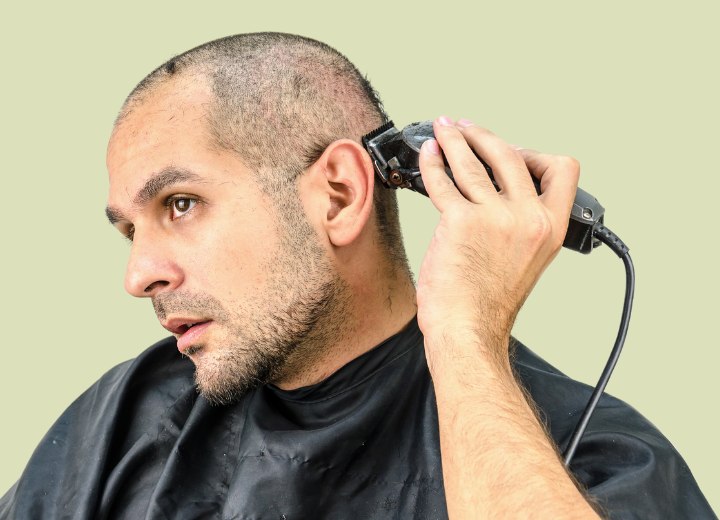 Uomo che si sta radendo la testa calva